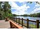 Relaxing lake view from a wooden deck with built-in benches and railings at 7912 Estates Dr, Sarasota, FL 34243