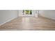 Bright living space with wood floors, large windows, and smooth transition to other areas of the home at 7912 Estates Dr, Sarasota, FL 34243