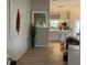 Open-concept living area with stylish decor, wood floors, and views into the modern kitchen at 7912 Estates Dr, Sarasota, FL 34243