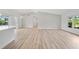 Bright and airy living space featuring wood floors, modern lighting, and seamless access to the backyard at 7912 Estates Dr, Sarasota, FL 34243