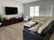 Comfortable living room boasts a wicker sectional sofa and a flat screen television at 7912 Estates Dr, Sarasota, FL 34243