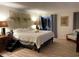 Calm bedroom featuring a king-size bed, stylish decor, and sliding glass doors to the outside at 7912 Estates Dr, Sarasota, FL 34243