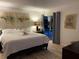 Serene bedroom featuring a comfortable bed, soft lighting, and access to outdoor pool area at 7912 Estates Dr, Sarasota, FL 34243