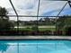 Inviting screened-in pool area with views of the pond and surrounding properties at 7912 Estates Dr, Sarasota, FL 34243