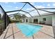An inviting in-ground pool sits within a screened enclosure, offering a private outdoor retreat with ample seating at 7912 Estates Dr, Sarasota, FL 34243