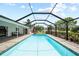 Large, inviting pool with a screened enclosure, offering a private outdoor living and entertainment space at 7912 Estates Dr, Sarasota, FL 34243