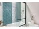 Modern bathroom showcasing a glass shower with beautiful teal herringbone tile at 8001 20Th W Pl, Bradenton, FL 34209