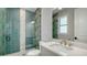 Beautiful bathroom with a glass shower, green tile and quartz countertop sink at 8001 20Th W Pl, Bradenton, FL 34209