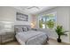 Bright bedroom with a cozy bed, palm tree view and decorative dolphin artwork at 8001 20Th W Pl, Bradenton, FL 34209