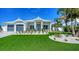 Beautiful home with a manicured lawn and tropical landscaping at 8001 20Th W Pl, Bradenton, FL 34209
