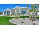 Well-maintained house with a green lawn, tropical landscaping, and a two car garage at 8001 20Th W Pl, Bradenton, FL 34209