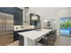 Kitchen with large island, marble countertops, stainless steel appliances, and pendant lighting at 8001 20Th W Pl, Bradenton, FL 34209
