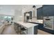Kitchen featuring a large island with seating, modern appliances, and stylish cabinets at 8001 20Th W Pl, Bradenton, FL 34209