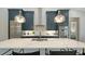 Kitchen featuring a large island, stainless steel appliances, modern cabinets, and pendant lighting at 8001 20Th W Pl, Bradenton, FL 34209