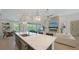 Open kitchen with marble island, modern appliances, and flow into the living and dining spaces at 8001 20Th W Pl, Bradenton, FL 34209