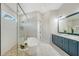 Luxury main bathroom with a standalone tub, glass shower, and stylish vanity with dual sinks at 8001 20Th W Pl, Bradenton, FL 34209