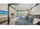 Spacious main bedroom boasts a four-poster bed, view of the pool, and soothing, cool color tones at 8001 20Th W Pl, Bradenton, FL 34209