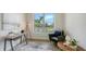 Bright office space with a dark desk, cozy green chair, a neutral rug, and natural light at 8001 20Th W Pl, Bradenton, FL 34209