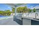 Enjoy an outdoor kitchen, complete with a grill, storage, and a sink, overlooking the pool at 8001 20Th W Pl, Bradenton, FL 34209