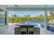 Outdoor living area featuring a fire pit table with waterfall pool view at 8001 20Th W Pl, Bradenton, FL 34209