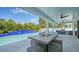 Outdoor living area with a fire pit table, grill and a clear view of the beautiful pool at 8001 20Th W Pl, Bradenton, FL 34209