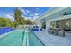 Inviting pool and spa with waterfall feature, outdoor dining area, and seamless indoor-outdoor living at 8001 20Th W Pl, Bradenton, FL 34209