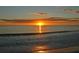 Breathtaking sunset over the ocean with golden light reflecting on the water and beach at 8001 20Th W Pl, Bradenton, FL 34209