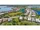 Stunning aerial view of a Primary-planned community featuring sparkling lakes and well-manicured landscaping under a clear blue sky at 8229 Grande Shores Dr, Sarasota, FL 34240