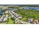 Expansive aerial view of a community, showcasing beautiful homes, serene lakes, and lush green spaces under a clear sky at 8229 Grande Shores Dr, Sarasota, FL 34240