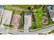 Overhead aerial view of a home with a screened-in lanai, lush landscaping, and a paved driveway, nestled in a neighborhood at 8229 Grande Shores Dr, Sarasota, FL 34240