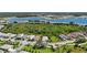 Scenic aerial view of a neighborhood with lush green spaces and a large lake, offering a serene and picturesque setting at 8229 Grande Shores Dr, Sarasota, FL 34240