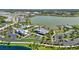 Breathtaking aerial view of community amenities, showcasing the clubhouse, pool, surrounding lake, and well-manicured landscaping at 8229 Grande Shores Dr, Sarasota, FL 34240