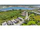 Wide aerial view of a residential community with stunning lake views, lush landscaping, and serene neighborhood streets at 8229 Grande Shores Dr, Sarasota, FL 34240