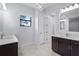 Bright bathroom with double vanity, dark cabinetry, and modern fixtures at 8229 Grande Shores Dr, Sarasota, FL 34240