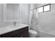 Modern bathroom features a stylish vanity, toilet, and a shower/tub combo with tiled walls at 8229 Grande Shores Dr, Sarasota, FL 34240