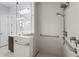 Modern bathroom featuring a shower with grab bars and tile surround at 8229 Grande Shores Dr, Sarasota, FL 34240