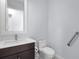Modern bathroom features a stylish vanity, toilet, and accessibility grab bar at 8229 Grande Shores Dr, Sarasota, FL 34240