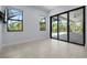 Bright bedroom featuring tile floors, bright windows, and access to a patio or pool area at 8229 Grande Shores Dr, Sarasota, FL 34240
