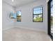 Bedroom with tile floors, bright windows, and access to a patio or pool area at 8229 Grande Shores Dr, Sarasota, FL 34240