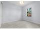 Bright, empty bedroom with natural light streaming through the window and clean, tile floors at 8229 Grande Shores Dr, Sarasota, FL 34240