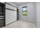 Bedroom featuring a built in Murphy bed, closet space and ample lighting at 8229 Grande Shores Dr, Sarasota, FL 34240