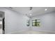 Bright bedroom with tile flooring, large windows, and neutral paint scheme at 8229 Grande Shores Dr, Sarasota, FL 34240