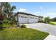 Beautifully landscaped home with a spacious three-car garage and paver driveway at 8229 Grande Shores Dr, Sarasota, FL 34240
