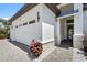 Charming home exterior featuring stone accents, a tiled entryway, and a three-car garage at 8229 Grande Shores Dr, Sarasota, FL 34240