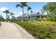 Attractive community building with lush landscaping, sidewalk, and parking at 8229 Grande Shores Dr, Sarasota, FL 34240