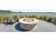 Outdoor fire pit with Adirondack chairs overlooking the lake at 8229 Grande Shores Dr, Sarasota, FL 34240