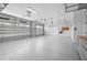 Spacious three car garage with epoxy flooring, overhead storage, and side storage cabinets at 8229 Grande Shores Dr, Sarasota, FL 34240
