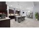 Modern kitchen with stainless steel appliances, island seating, and custom lighting at 8229 Grande Shores Dr, Sarasota, FL 34240