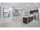 Modern open-concept kitchen with stainless steel appliances, white countertops, and large island at 8229 Grande Shores Dr, Sarasota, FL 34240