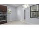 Spacious kitchen nook area featuring stainless steel appliances and natural light from the exterior at 8229 Grande Shores Dr, Sarasota, FL 34240